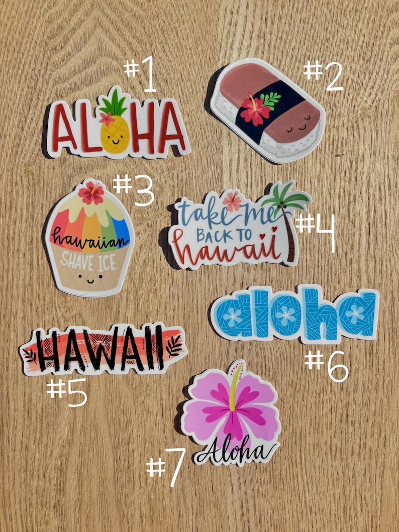 May include: Seven colorful stickers with Hawaiian themes. The stickers feature phrases like "Aloha", "Take Me Back To Hawaii", and "Hawaiian Shave Ice".