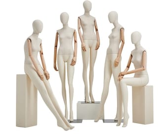 May include: Five white fabric mannequins with wooden arms and legs. The mannequins are posed in different positions, some sitting and some standing. The mannequins are on a white background.