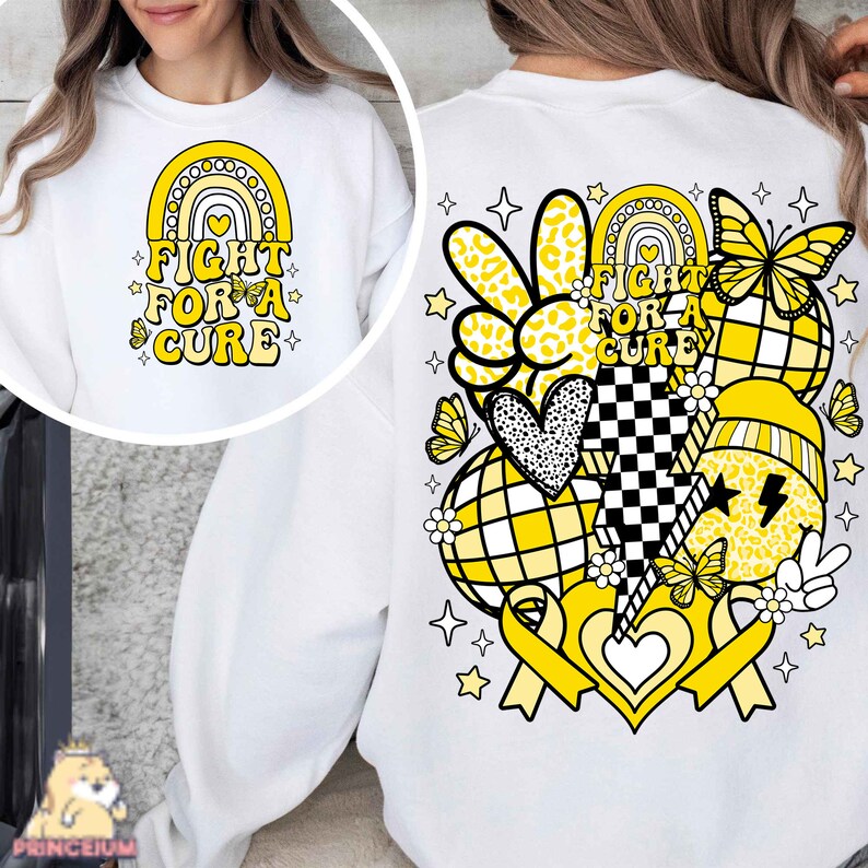 May include: White sweatshirt with a yellow and black design on the back. The design includes a rainbow, a heart, a peace sign, a butterfly, a ribbon, and the text "Fight for a Cure".