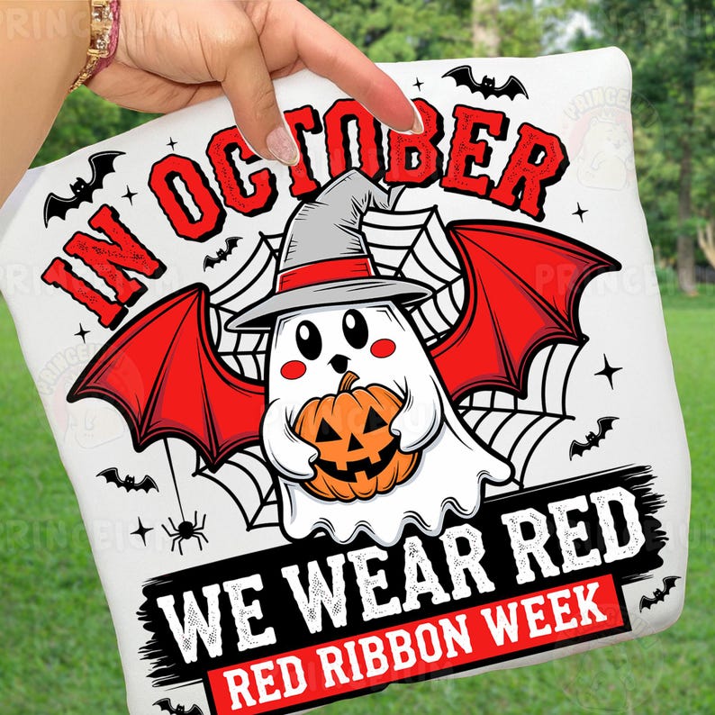 May include: White Halloween-themed pillow with a cartoon ghost wearing a witch hat and holding a pumpkin. The text "IN OCTOBER WE WEAR RED RED RIBBON WEEK" is displayed in red and black.