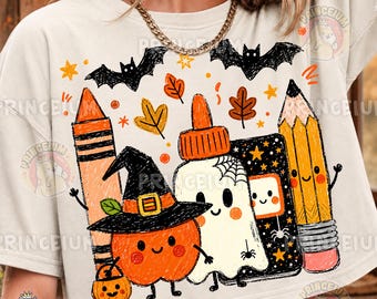 May include: A cream-coloured t-shirt featuring a graphic print of a smiling orange pumpkin wearing a witch hat, a white ghost, a yellow pencil, an orange crayon, and a glue bottle, surrounded by black bats, orange leaves, and small stars.
