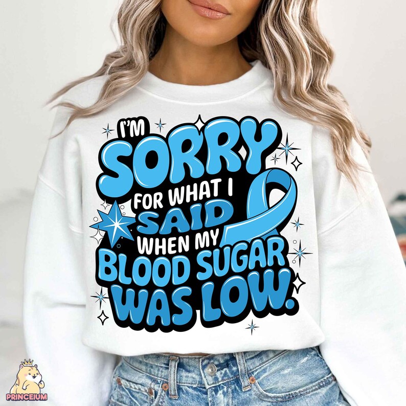 May include: White sweatshirt with a blue ribbon and the text "I'm sorry for what I said when my blood sugar was low."