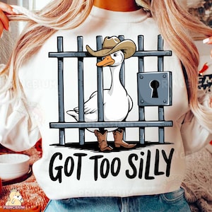 May include: White sweatshirt with a cartoon goose wearing a cowboy hat and boots behind bars. The text "GOT TOO SILLY" is printed below the image.