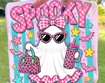 May include: A light pink t-shirt featuring a graphic of a white ghost wearing pink checkered sunglasses and a matching bow. The ghost holds a pink leopard print handbag and a tumbler. The text SPOOKY appears above, surrounded by stars and bats.