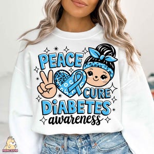 May include: White sweatshirt with a blue ribbon, peace sign, and heart with the text "Peace Cure Diabetes awareness".