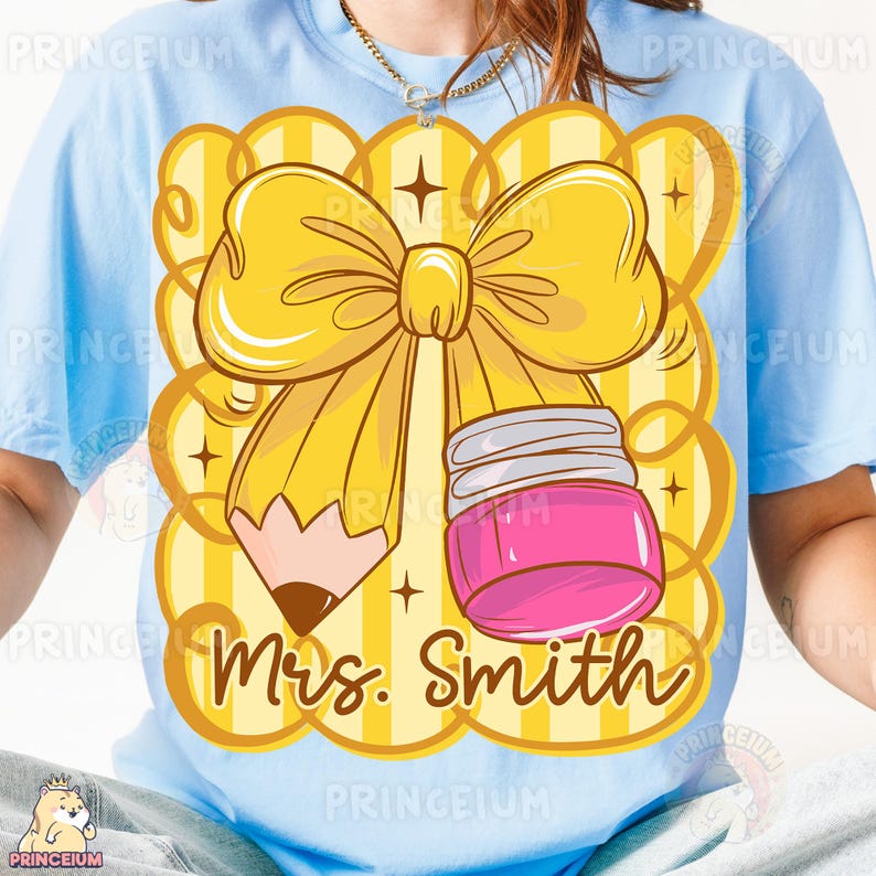May include: Light blue t-shirt featuring a yellow bow, pencil, and pink jar design. The design includes the text "Mrs. Smith" in a script font. The background has yellow stripes and decorative elements.