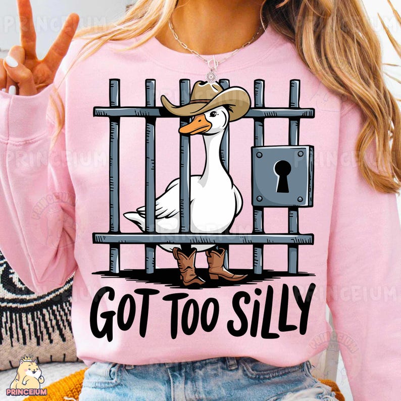 May include: A pink sweatshirt with a white goose wearing a cowboy hat and boots behind bars. The text "GOT TOO SILLY" is printed below the image.