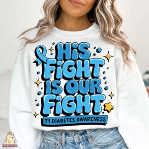 May include: White sweatshirt with a blue ribbon and the text "His Fight Is Our Fight" in blue letters with a yellow star. The text "T1 Diabetes Awareness" is printed below the main text.