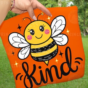 May include: Orange square with a cartoon bee illustration. The bee is yellow and black with white wings and pink cheeks. The word "Kind" is written in black script below the bee, with star accents.