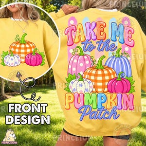 May include: A yellow sweatshirt featuring a graphic print of colourful pumpkins. The back design displays the text "TAKE ME to the PUMPKIN PATCH" in multi-coloured bubble letters above a cluster of pink, orange, and blue pumpkins with green leaves.