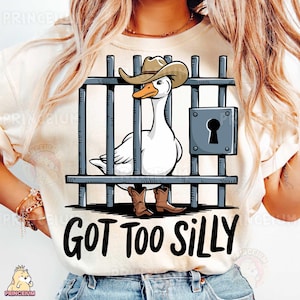 May include: A white t-shirt with a cartoon image of a goose wearing a cowboy hat and boots behind bars. The text "GOT TOO SILLY" is printed below the image.