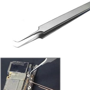 May include: A pair of silver-coloured tweezers with a bent tip. The tweezers are being used to manipulate a small electronic component on a circuit board.