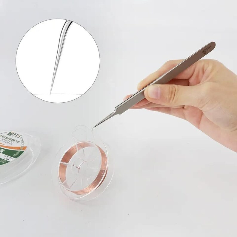 May include: A close-up of a pair of silver tweezers holding a thin copper wire. The wire is wound around a clear plastic spool. The tweezers have a sharp tip and are designed for precision work.