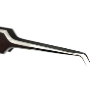 May include: A pair of stainless steel tweezers with a curved tip. The tweezers are designed for precision work, such as picking up small objects or applying adhesives.