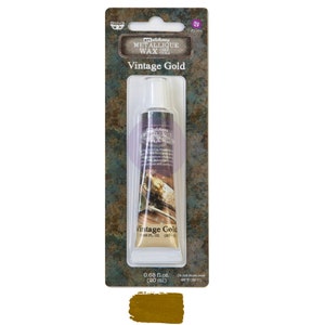 May include: A tube of Art Alchemy Metallic Wax in Vintage Gold. The tube is 0.68 fl. oz. (20 ml) and contains a gold coloured wax.