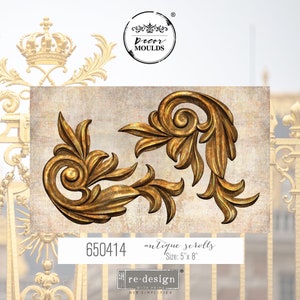 May include: Two gold-toned antique scroll designs, each with a swirling center and intricate leaf details. The scrolls are 5 inches by 8 inches and are part of a re-design with Prima DIY Simplified collection.