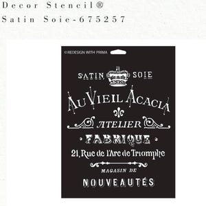 May include: Black stencil with white text, including "Satin Soie" and "Au Vieil Acacia". The stencil also features the text "Atelier", "Fabrique", and "21, Rue de l'Arc de Triomphe". The stencil is a "Decor Stencil" product.