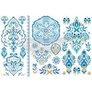 May include: A set of blue and gold watercolor decals featuring intricate floral and geometric patterns. The decals include a large mandala, smaller floral motifs, and a repeating border pattern.