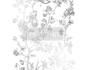 Puede incluir: Una hoja de transferencia plateada con un diseño floral que presenta un pájaro y ramas. La hoja es de la línea Re-Design with Prima y dice "DIY Simplified".