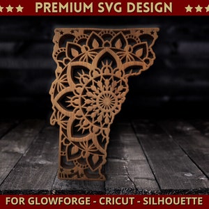 May include: A wooden cutout of the state of Vermont, featuring a detailed mandala design. The cutout is a light brown color and has intricate patterns. Text at the top reads "PREMIUM SVG DESIGN" and at the bottom "FOR GLOWFORGE - CRICUT - SILHOUETTE".