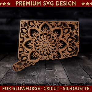 May include: A wooden cutout of the state of Connecticut with a mandala design. The design is intricate and detailed, with a variety of shapes and patterns. The cutout is perfect for use in home decor, crafts, or as a gift.