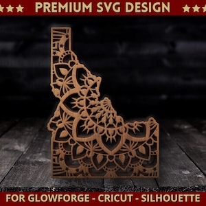 May include: A wooden cutout of the state of Idaho, featuring intricate mandala-style designs. The state outline is brown, with detailed patterns carved throughout. The text "PREMIUM SVG DESIGN" and "FOR GLOWFORGE - CRICUT - SILHOUETTE" are visible.