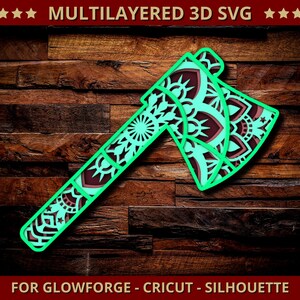 Könnte beinhalten: Ein mehrschichtiges 3D-SVG-Design einer Axt mit dekorativem Mandala-Muster. Die Axt hat einen türkisfarbenen Umriss und komplizierte Ausschnitte mit einem dunkelroten und türkisfarbenen Farbschema. Der Text oben lautet "MULTILAYERED 3D SVG".