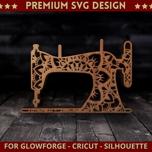 May include: A laser-cut wooden sewing machine design with floral patterns. The design includes the text "PREMIUM SVG DESIGN" and "FOR GLOWFORGE - CRICUT - SILHOUETTE". The sewing machine is brown and rests on a wooden surface.