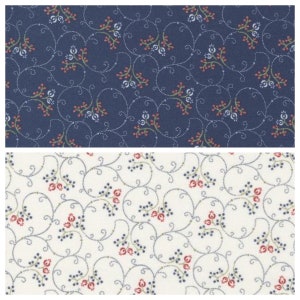 May include: Two fabric swatches with a repeating pattern of small red berries, green leaves, and white flowers on a blue and white background. The pattern is a delicate floral design with a vintage feel.
