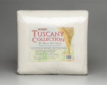May include: A white package of Hobbs Tuscany Collection Cotton Wool Blend batting. The package has a label with a colorful illustration of an archway and the text "Hobbs Tuscany Collection The Ultimate Quilt Batting Designed for Quilting Detail Cotton Wool Blend".
