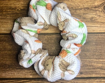 May include: White scrunchie with a brown bunny and carrot print.
