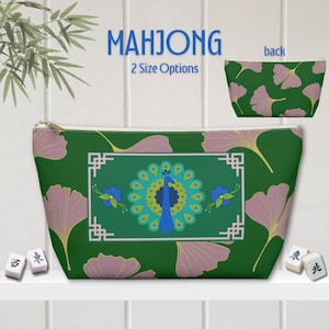 May include: A green zippered pouch with a peacock design, framed by a white border. The pouch features a ginkgo leaf pattern and the word "MAHJONG". The back of the pouch has a ginkgo leaf pattern. Two size options are available.