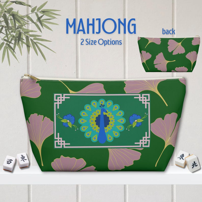 May include: A green zippered pouch with a peacock design, framed by a white border. The pouch features a ginkgo leaf pattern and the word "MAHJONG". The back of the pouch has a ginkgo leaf pattern. Two size options are available.
