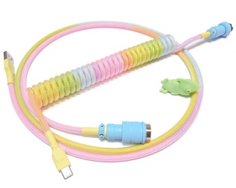 May include: A coiled rainbow colored USB cable with a light blue connector on one end and a yellow connector on the other end. The cable is coiled in a circle and the connectors are facing each other.