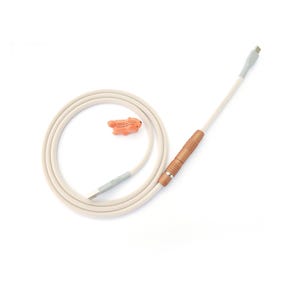 May include: A cream-coloured charging cable with a USB-C connector and an orange fish-shaped charm. The cable has a copper-coloured grip and a white shaft. The cable is coiled on a white background.