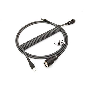 May include: A coiled gray and black USB-C cable with a detachable connector and a small panda figurine. The cable is designed for mechanical keyboards and other devices, with a coiled section for flexibility.
