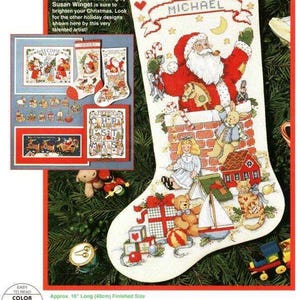 May include: A counted cross stitch pattern for a Christmas stocking featuring Santa Claus climbing down a chimney with toys. The stocking is 16 inches long and 40 centimetres. The pattern includes a personalised name banner with the name "MICHAEL".