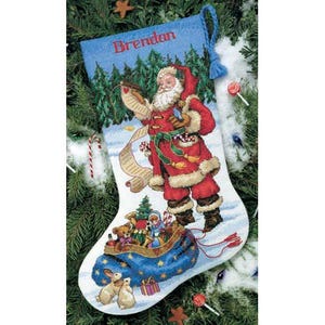 May include: A red and white Santa Claus stocking with a blue cuff and a tassel. The stocking is filled with toys and gifts. The stocking has the name "Brendan" embroidered on the cuff.