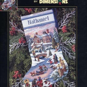 May include: A cross-stitch pattern for a Christmas stocking featuring a winter scene with a house, a bridge, and people ice skating. The stocking is personalised with the name "Nathaniel" and the text "Winter's Twilight Stocking".