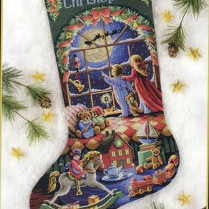 May include: A Christmas stocking with the name "Christopher" embroidered on it. The stocking is decorated with a winter scene, including a window with a view of Santa Claus flying in the sky, a rocking horse, and a teddy bear.