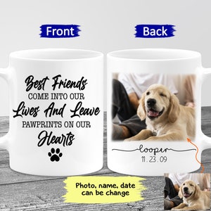 May include: White ceramic coffee mug with a black paw print and the text "Best Friends Come Into Our Lives And Leave Pawprints On Our Hearts". The back of the mug has a photo of a golden retriever puppy with the text "looper 11.23.09" underneath.