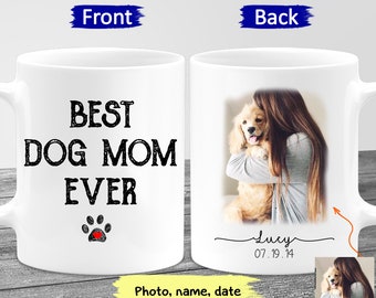 May include: White ceramic mug with black text that reads "Best Dog Mom Ever" and a red paw print. The back of the mug has a photo of a woman holding a dog, with the text "Lucy 07.19.14" underneath.