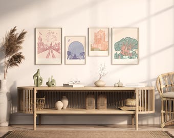 May include: A light wood media console with slatted sides and an open shelf, featuring four framed art prints on the wall above. The prints depict a castle, a large sphere, a tall building, and a tree. Decorative vases and a straw hat are present.
