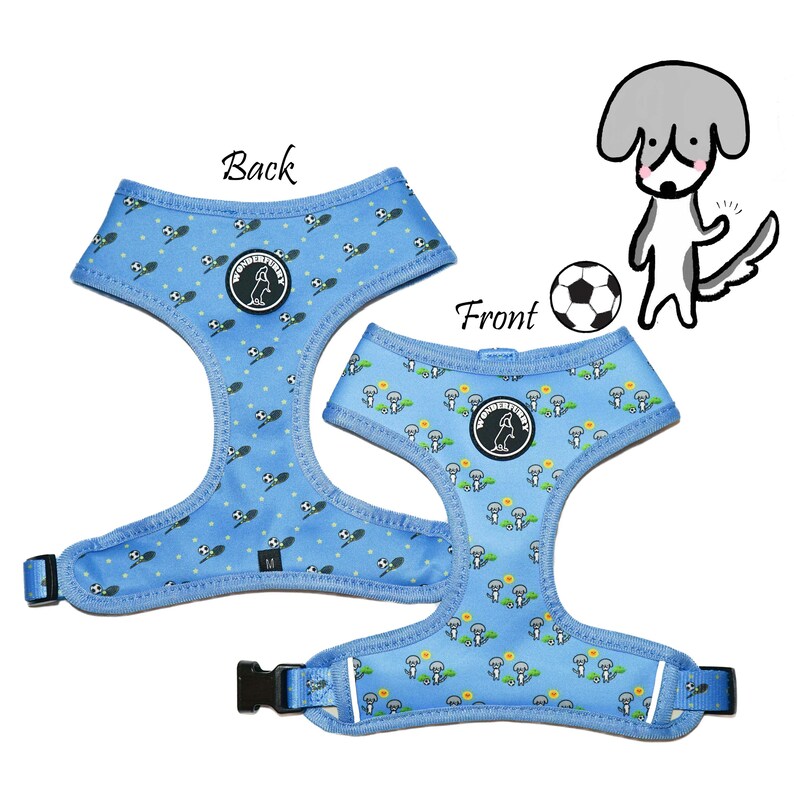May include: Two light blue dog harnesses with a repeating pattern of soccer balls and cartoon dogs. The harnesses have black buckles and the text "Back" and "Front" are visible. A cartoon dog and soccer ball are also in the image.