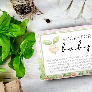 May include: A pink and green baby shower invitation card with a cute cartoon sprout illustration. The text reads "Books for baby. One small request, we hope it's not too hard please bring a book instead of a card. We will cherish the book, well loved or brand new please sign the inside with a message just from you!"