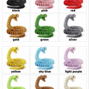 May include: A collection of colorful, articulated snake toys in various colors, including white, blue, purple, black, pink, red, gold, green, silver, yellow, sky blue, light purple, light green, brown, bone white, grey, orange, and light brown. Each snake has a detailed design.