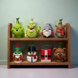 May include: A wooden shelf displays eight novelty soap dispensers. The dispensers are shaped like holiday characters, including the Grinch, a ghost, a gnome, a reindeer, a nutcracker, a snowman, Santa Claus, and a bear. Each dispenser has a pump nozzle.