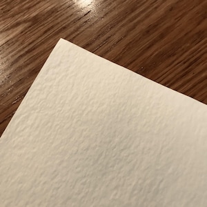 Puede incluir: Primer plano de una superficie de papel texturizada blanca.