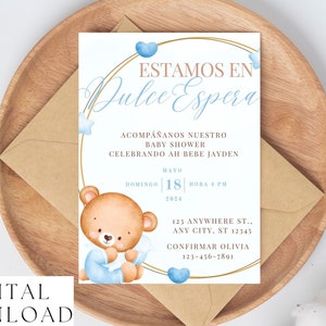 May include: A baby shower invitation with the text "ESTAMOS EN Dulce Espera" in elegant script, featuring a watercolor teddy bear and blue accents. The invitation includes details for the event, such as the date, time, and location, and is a digital download.