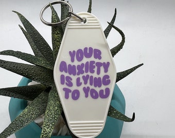 votre anxiété vous ment porte-clés de motel en vinyle